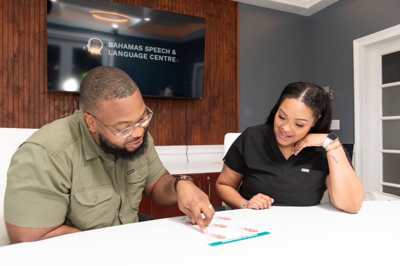 A therapist reviewing swallowing materials with an adult client