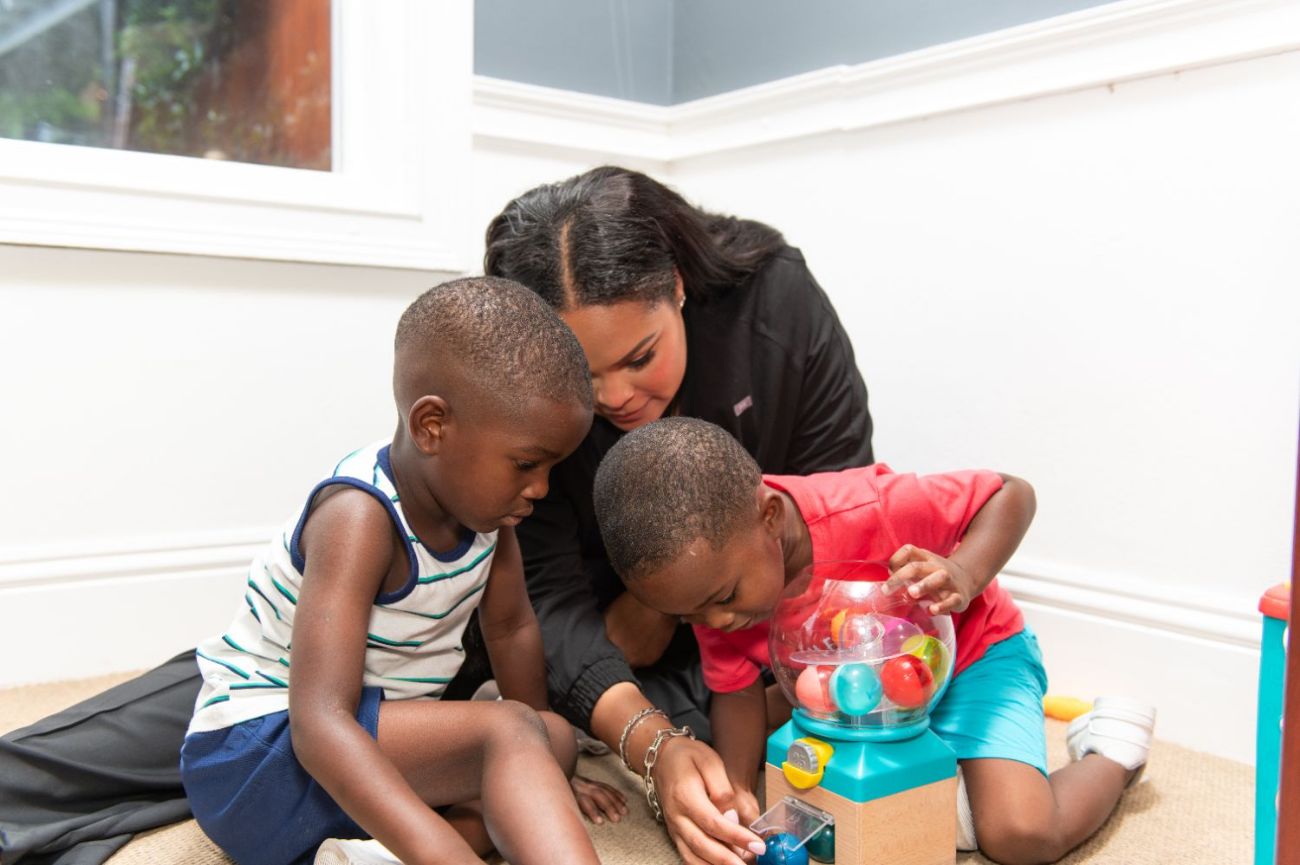 Children engaged with a cause-and-effect toy during therapy