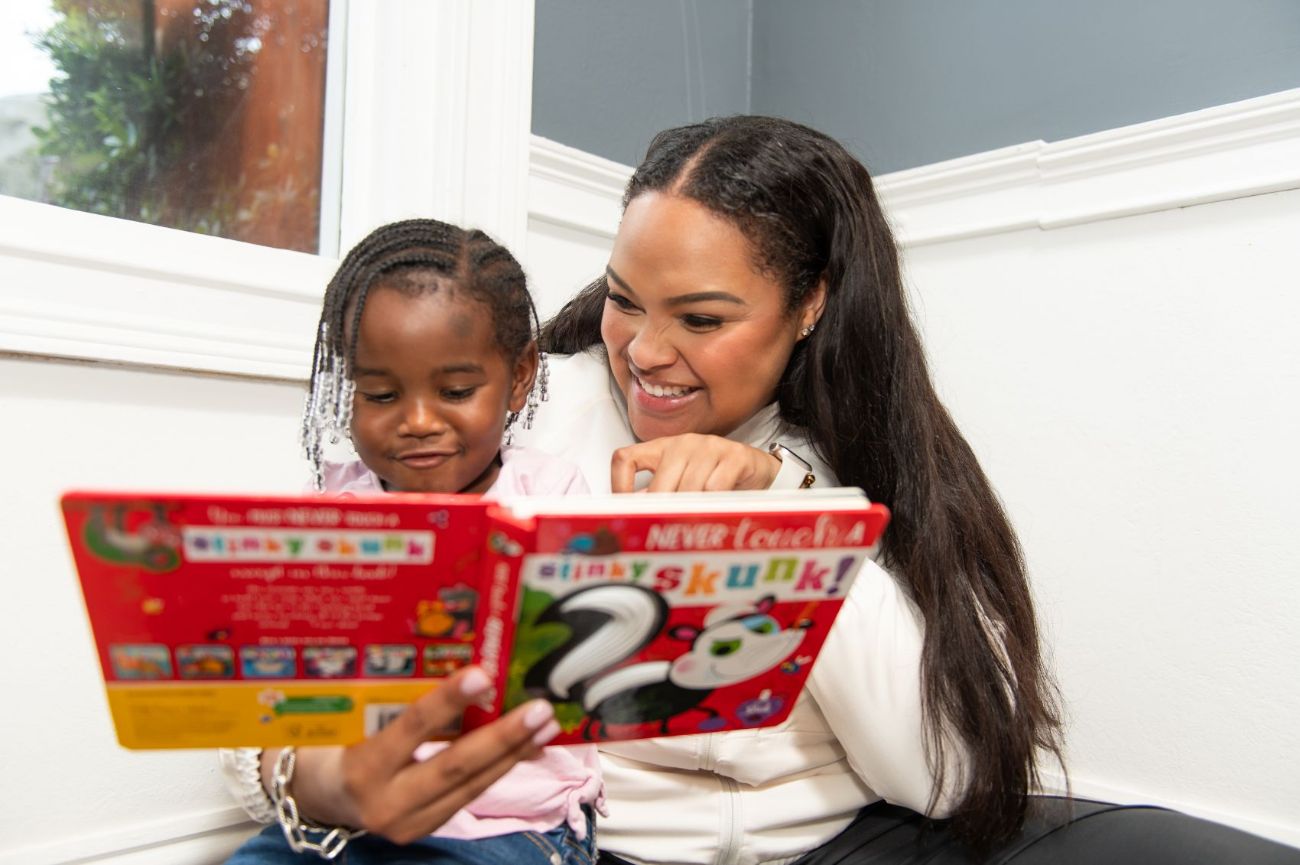 A therapist reading a picture book with a young child